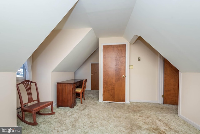 additional living space featuring carpet floors, lofted ceiling, and baseboards