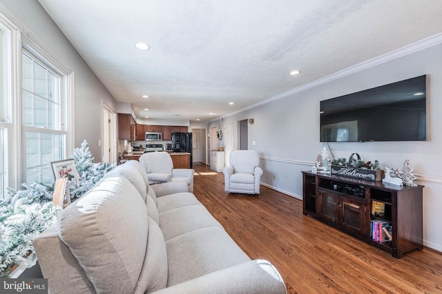 living area featuring ornamental molding, recessed lighting, baseboards, and wood finished floors