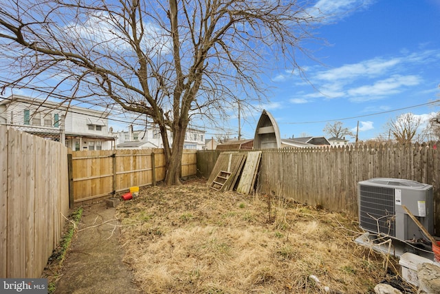 view of yard featuring a fenced backyard and central AC unit