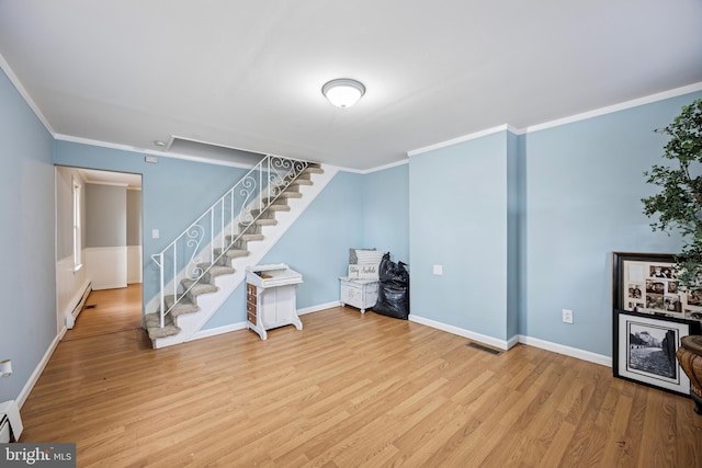 basement featuring a baseboard radiator, stairway, and wood finished floors