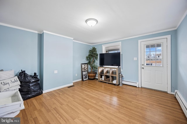 interior space featuring light wood-style floors, visible vents, and baseboard heating