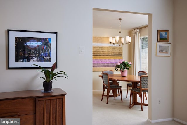 dining space with a chandelier and light carpet