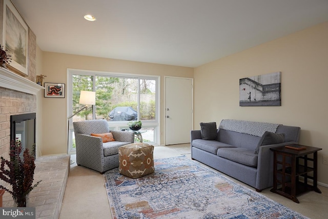 living area with light carpet, a brick fireplace, baseboards, and recessed lighting