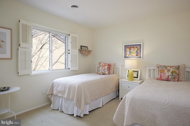 bedroom featuring light carpet and baseboards