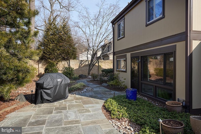 view of patio / terrace featuring fence and grilling area