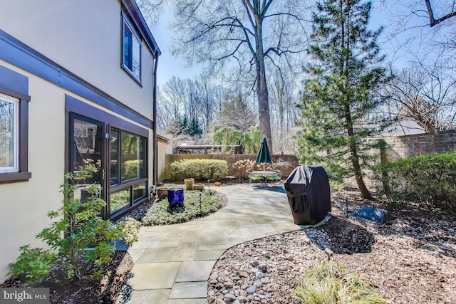 view of patio with grilling area and fence