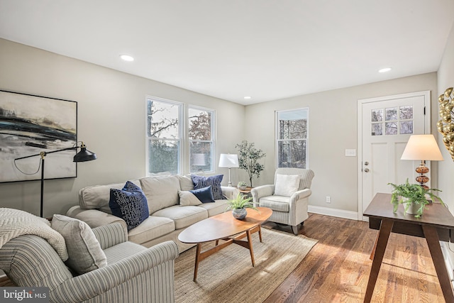 living area with dark wood-style floors, baseboards, and recessed lighting