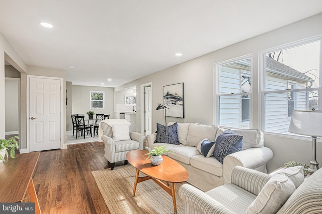 living room with baseboards, wood finished floors, and recessed lighting