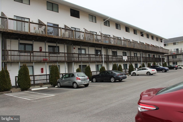 view of property featuring uncovered parking