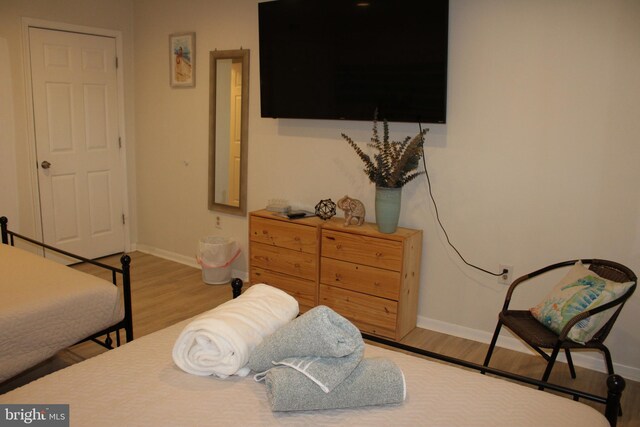 bedroom featuring baseboards and wood finished floors