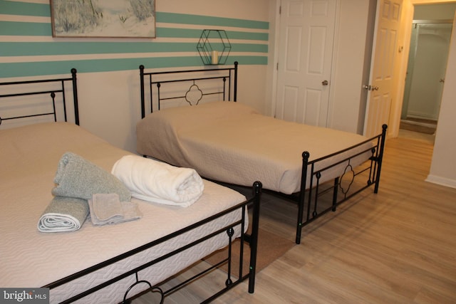 bedroom featuring baseboards and wood finished floors