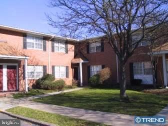 view of property featuring a front lawn