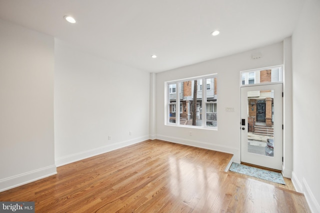 entryway featuring baseboards, light wood-style flooring, and recessed lighting