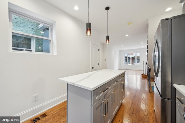 kitchen with light wood-style floors, recessed lighting, freestanding refrigerator, and gray cabinetry