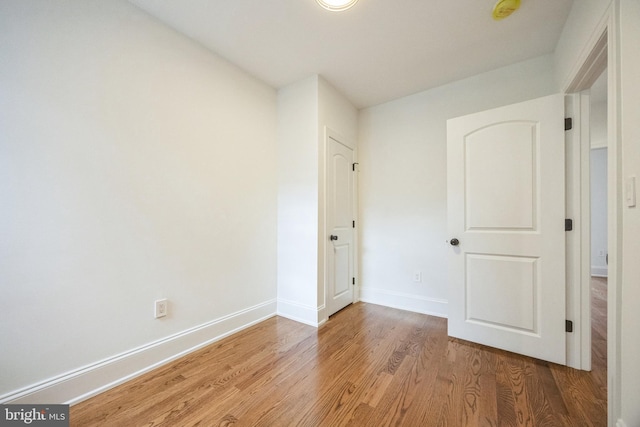 unfurnished bedroom featuring light wood finished floors and baseboards