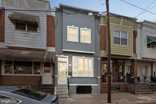 view of property featuring entry steps and stucco siding