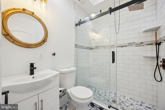 bathroom featuring vanity, a shower stall, and toilet