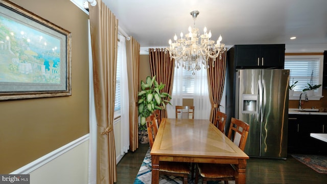 dining space with a chandelier and dark wood finished floors
