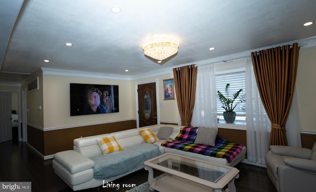 living room featuring baseboards, wood finished floors, crown molding, a notable chandelier, and recessed lighting