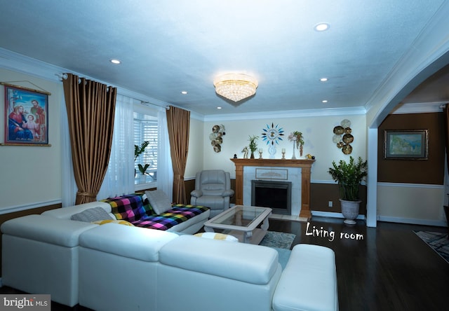 living room with a tiled fireplace, wood finished floors, recessed lighting, crown molding, and baseboards
