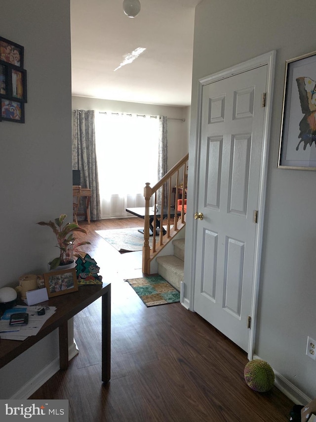 corridor featuring stairs and wood finished floors