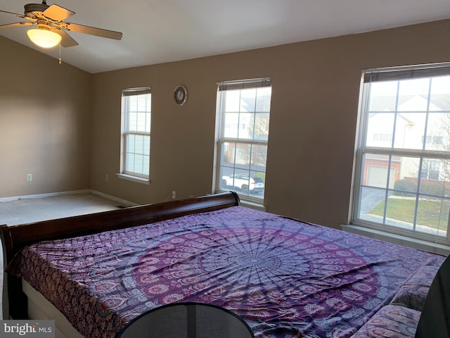 bedroom featuring vaulted ceiling, ceiling fan, and baseboards