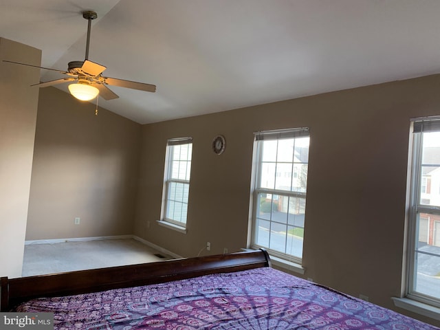 unfurnished bedroom featuring lofted ceiling, ceiling fan, and baseboards