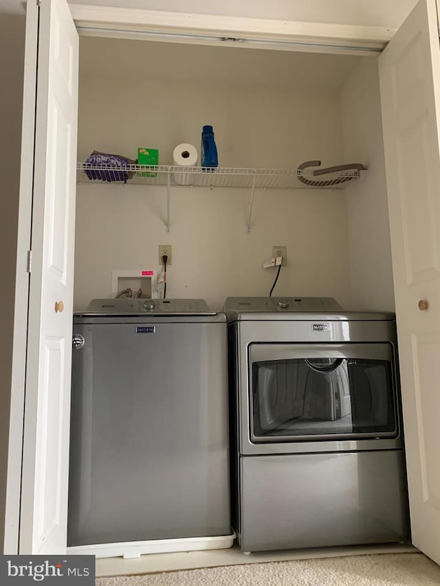 laundry room featuring washer and dryer and laundry area