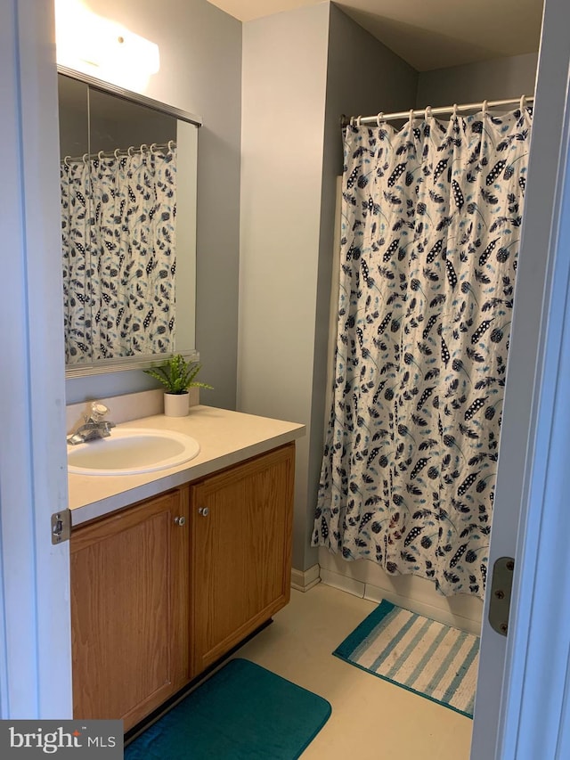 bathroom featuring shower / bath combo and vanity