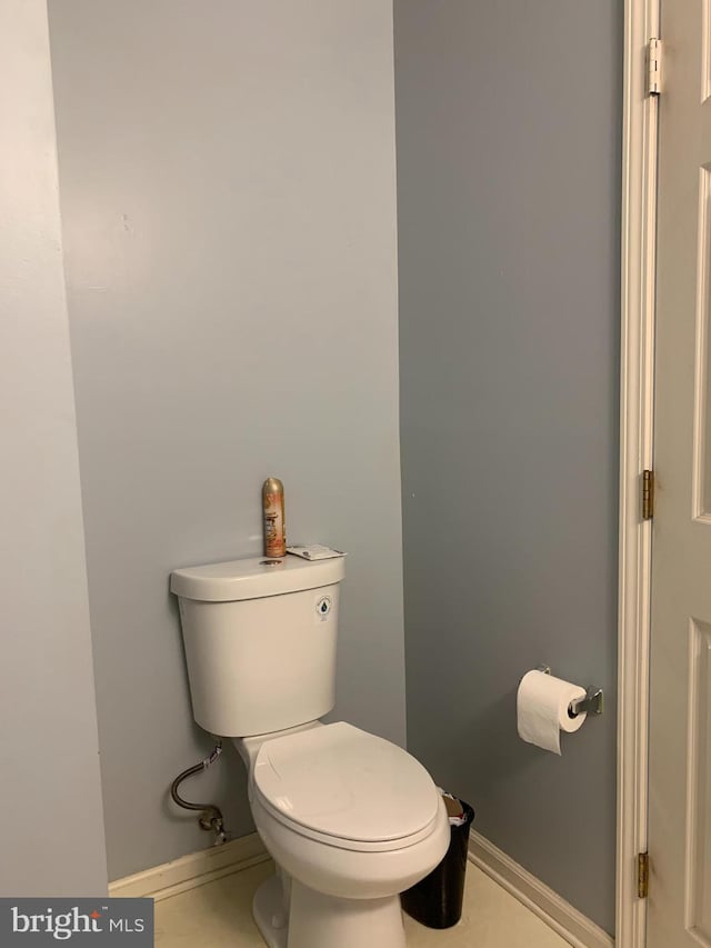 bathroom with toilet and baseboards