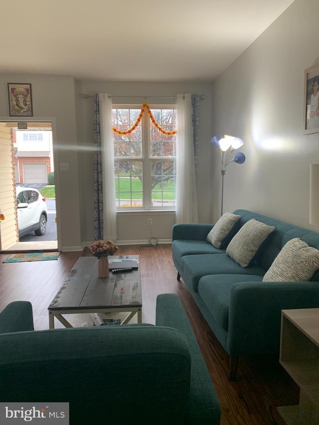 living area with wood finished floors and baseboards