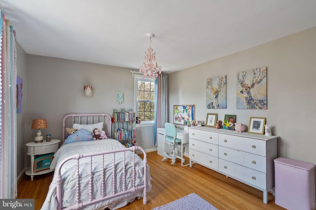 bedroom featuring wood finished floors and baseboards