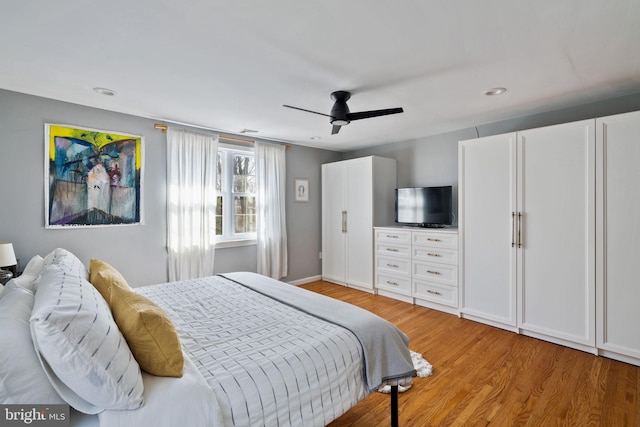 bedroom featuring light wood-style floors, ceiling fan, and baseboards