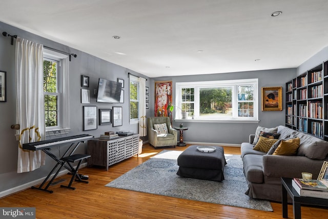 sitting room featuring a wealth of natural light, baseboards, and wood finished floors