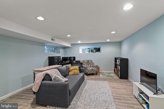 living area with wood tiled floor, visible vents, baseboards, and recessed lighting