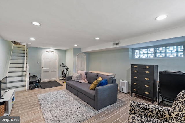 living room with stairs, wood finish floors, visible vents, and recessed lighting