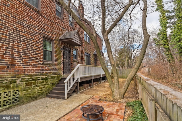 exterior space featuring a fire pit, a patio area, and fence