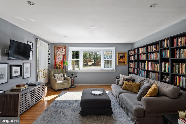 sitting room featuring recessed lighting, baseboards, and wood finished floors