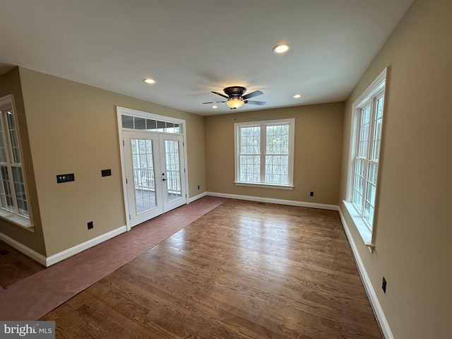 interior space featuring recessed lighting, baseboards, dark wood-style flooring, and french doors