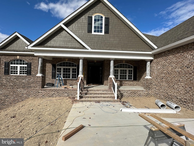 view of front of property with covered porch and brick siding