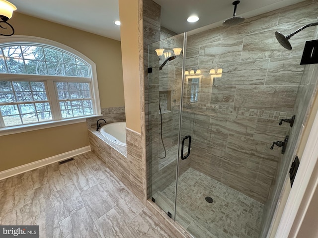 full bath featuring visible vents, a shower stall, baseboards, and a bath