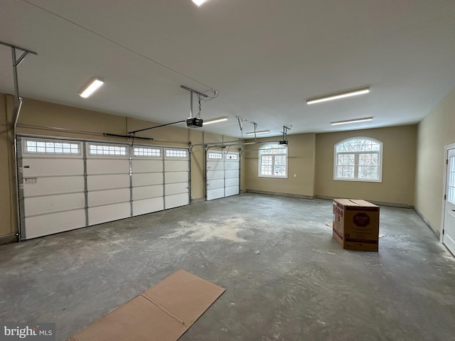 garage featuring baseboards and a garage door opener