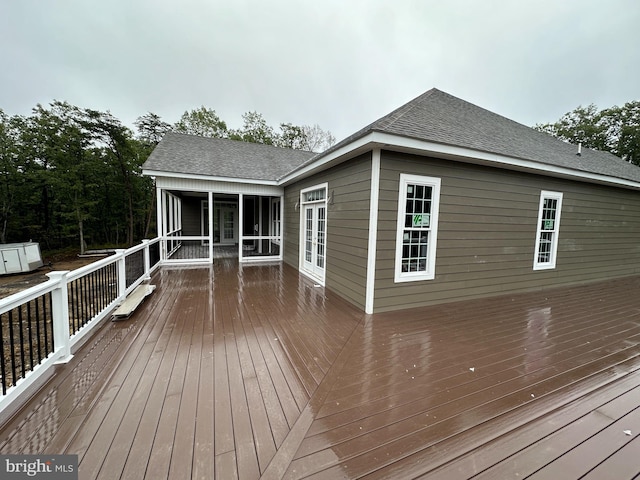 wooden deck with a sunroom