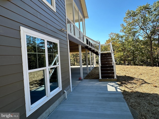 view of side of property with stairs and a deck