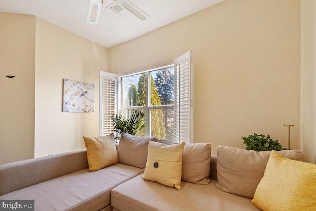 living area featuring visible vents and a ceiling fan