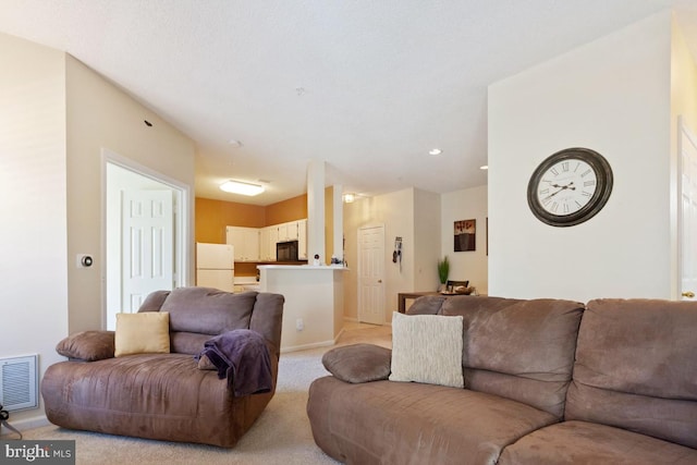 living area with light colored carpet, visible vents, and recessed lighting