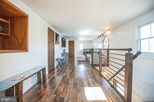 hallway featuring wood finished floors and an upstairs landing