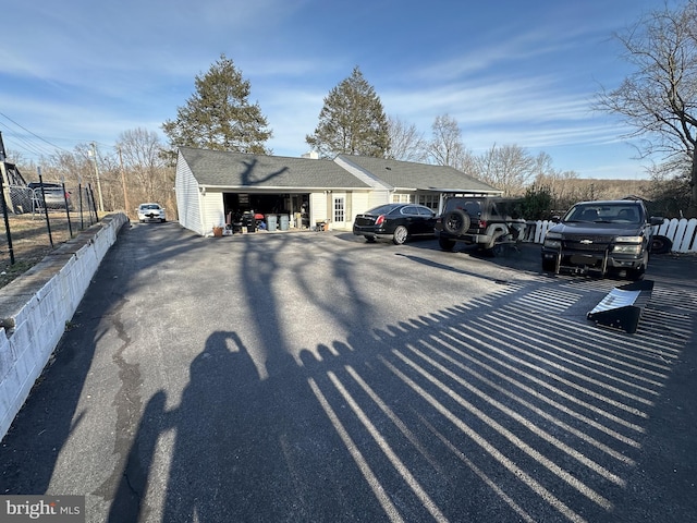 view of parking featuring fence