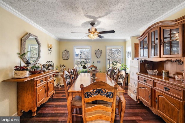 dining room with ceiling fan, dark wood-type flooring, a textured ceiling, and crown molding