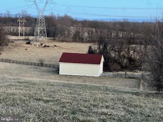 view of yard with a rural view and an outdoor structure